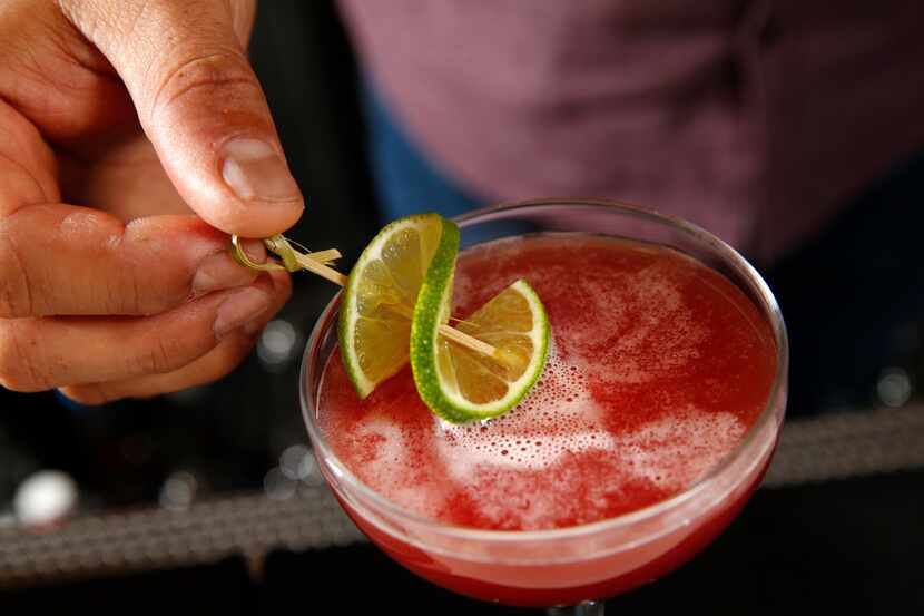 Bar manager Ravinder "Ravi" Singh puts a slice of lime on the Agave Gimlet at Jalisco Norte...