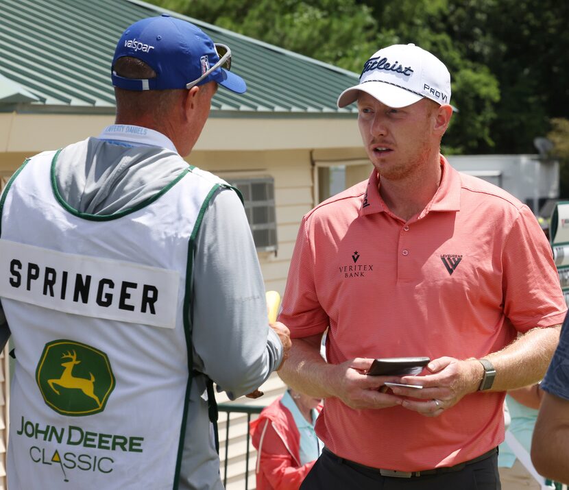 First-round leader Hayden Springer, right, talks with his caddie Michael Burns prior to...