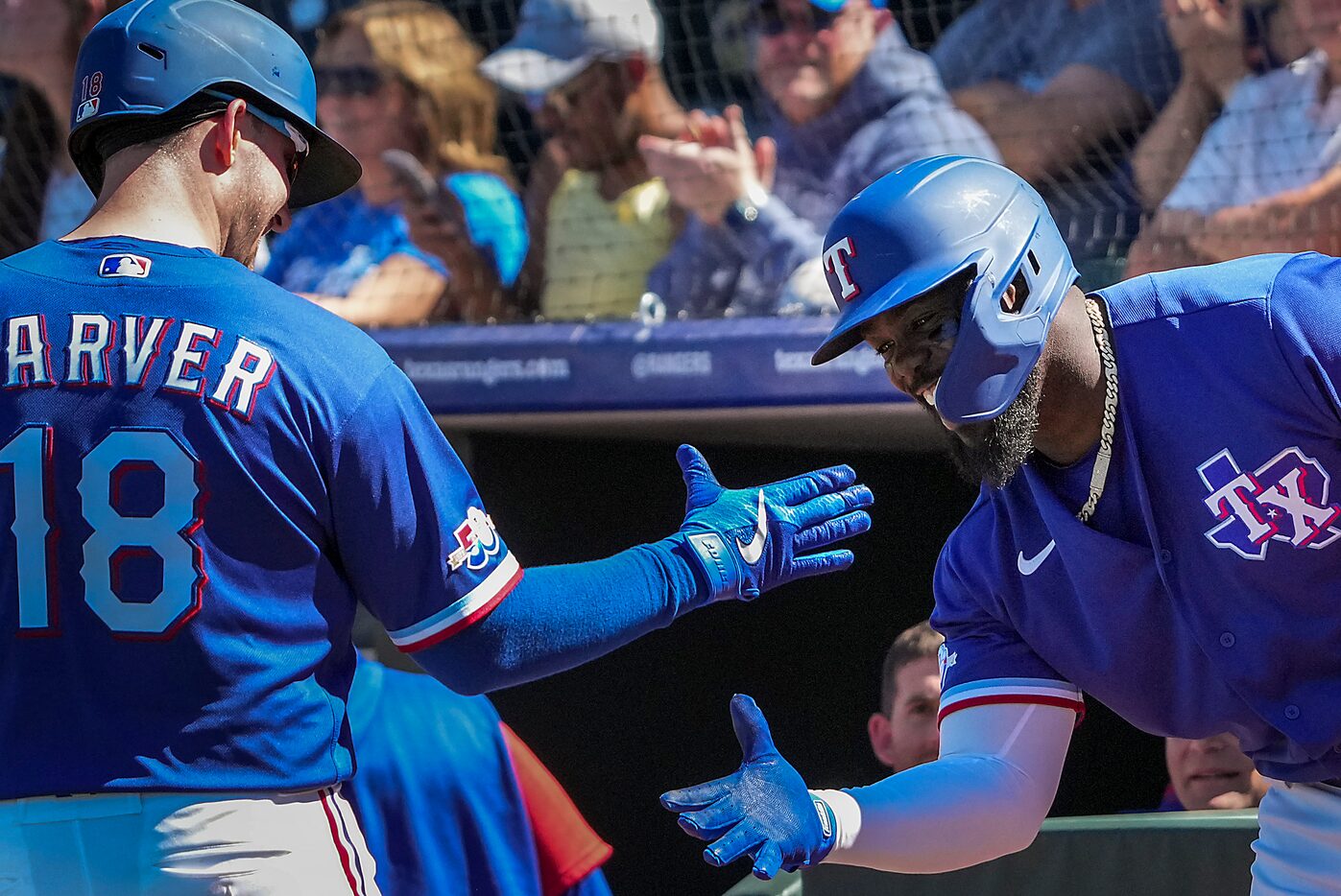 Texas Rangers catcher Mitch Garver celebrates with outfielder Adolis García after hitting a...