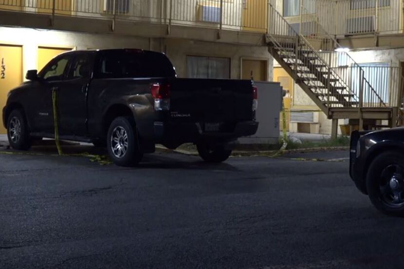 Police tape lies around a truck in a parking lot at a Red Bird area motel Tuesday night in...