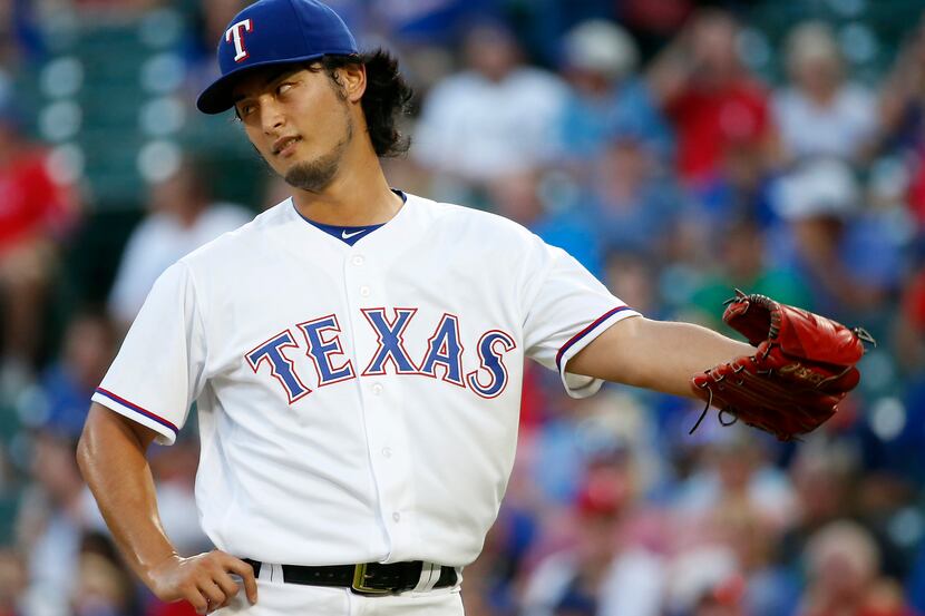 Rangers starting pitcher Yu Darvish (11) reacts after giving up a home run to Oakland...
