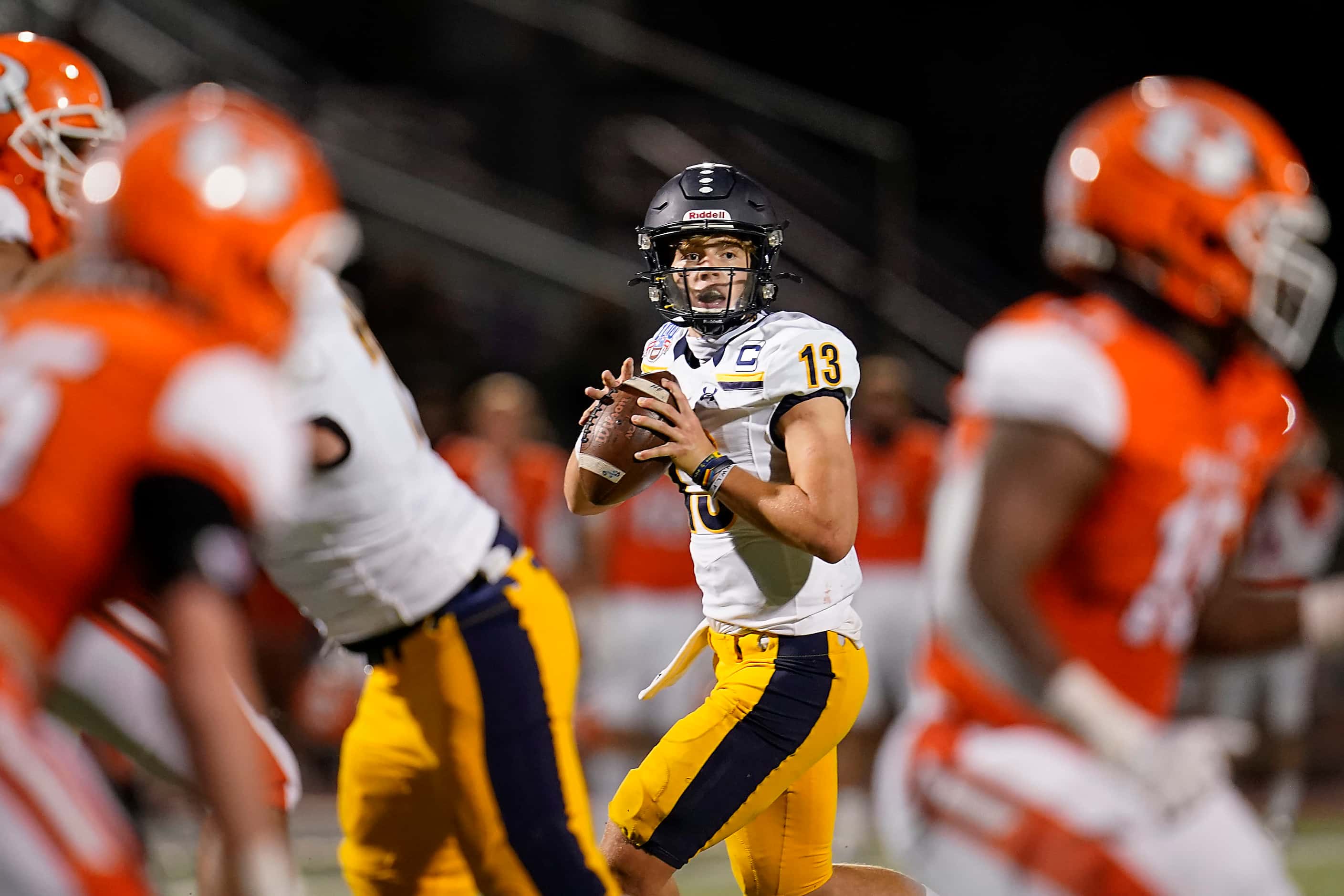 Highland Park quarterback Brayden Schager (13) looks for a receiver during the first half of...