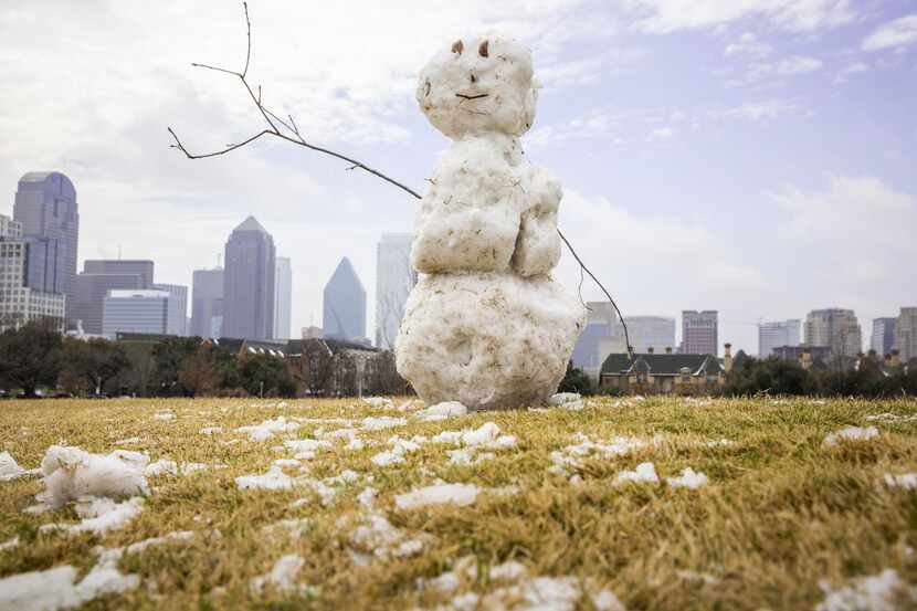A snowman sits atop a small hill in Griggs Park near downtown Dallas after a winter storm...