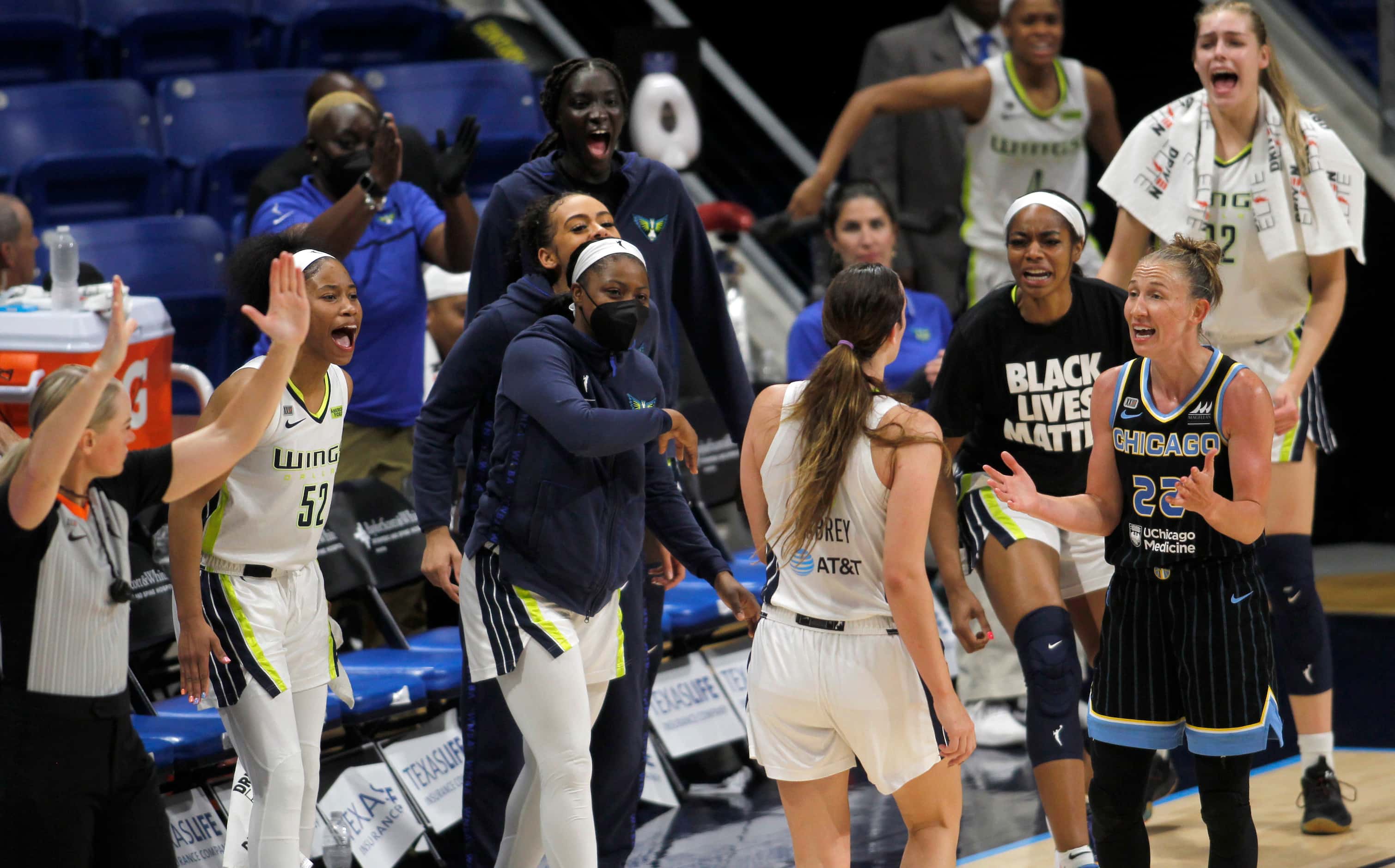 Dallas Wings guard Marina Mabrey (6) draws a reaction from the Wings bench after sinking a...