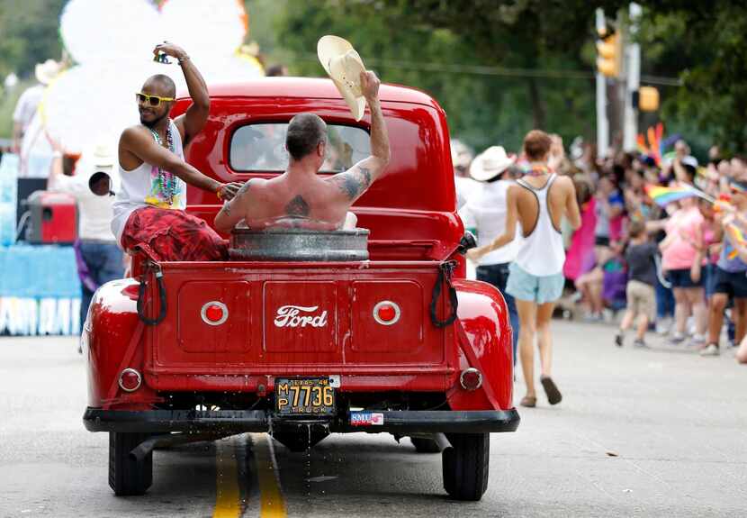 
Johnathan Williams (left) and Del Ray Brooks waved to spectators from a vintage pickup...