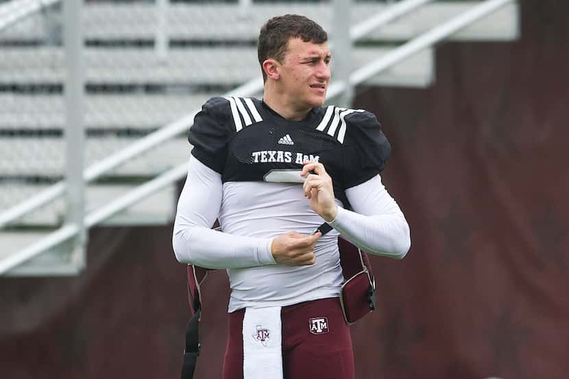 Texas A&M's Johnny Manziel buckles his pads before a scrimmage at spring NCAA college...
