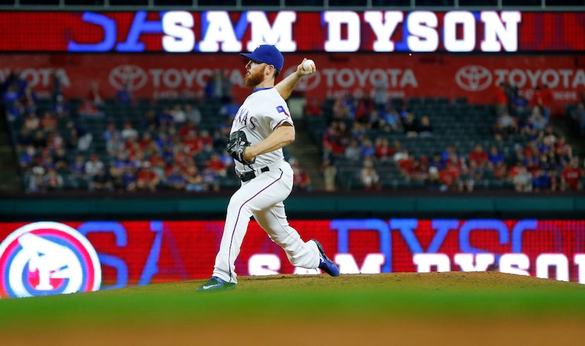 Texas Rangers relief pitcher Sam Dyson (47) warms up before throwing against the Milwaukee...