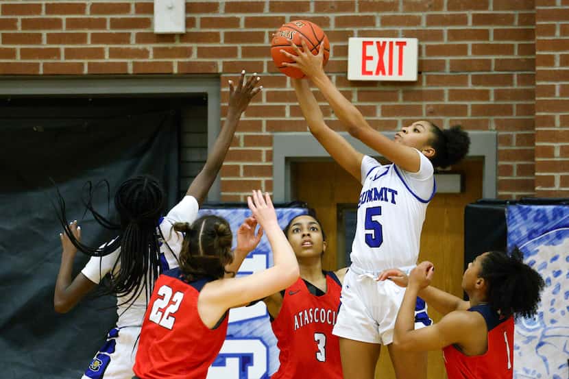 Mansfield Summit female basketball players in a game against Atascocita during the first...