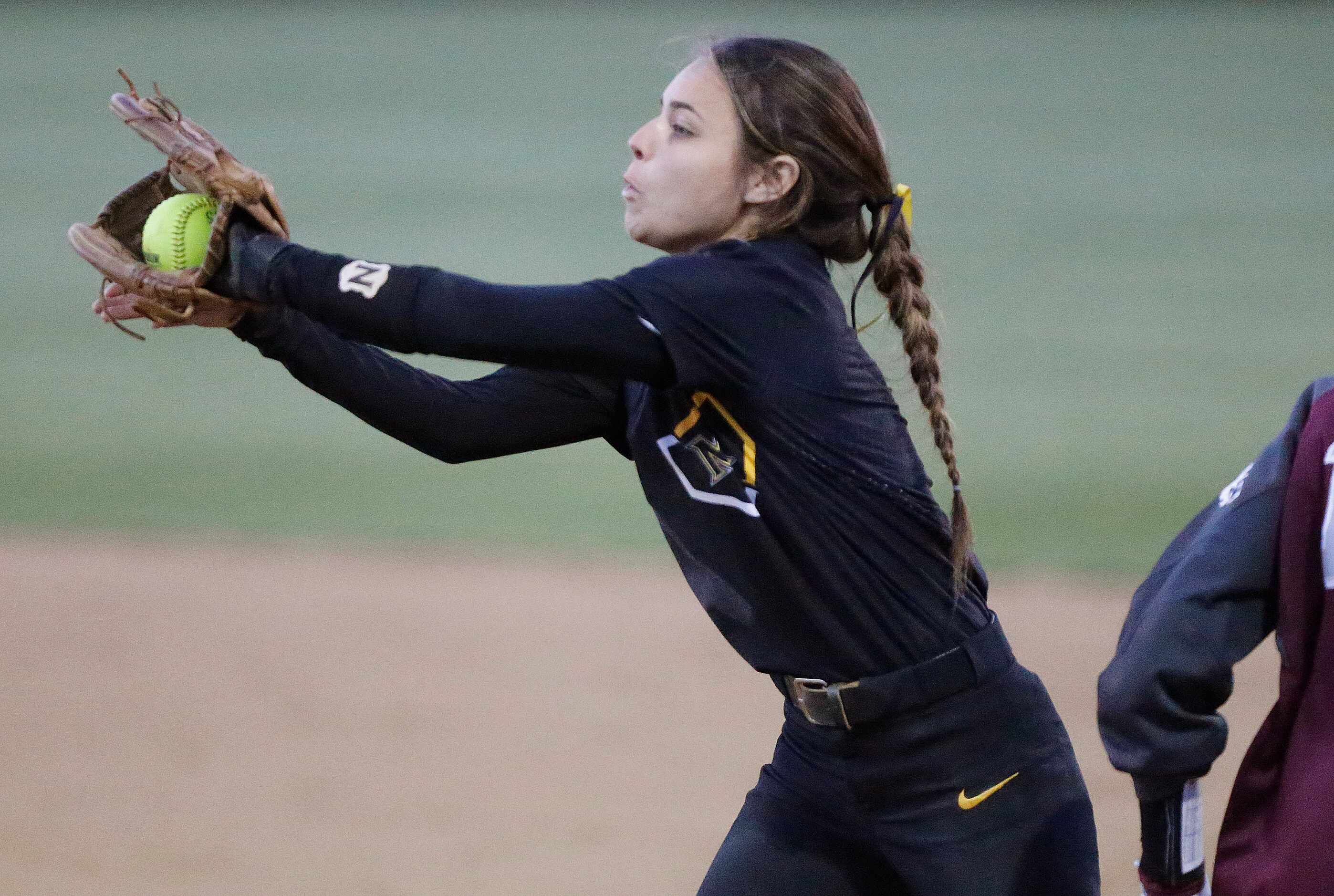 Memorial second baseman Ashley Camacho (2) covers first base and makes  an out in the third...