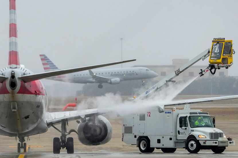 An American Airlines jet undergoes deicing procedures on Monday, Jan. 30, 2023, at DFW...