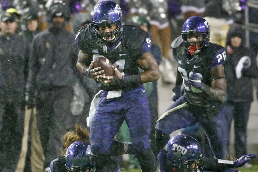 TCU Horned Frogs defensive end Josh Carraway (94) picks up a Baylor fumble and takes it to...
