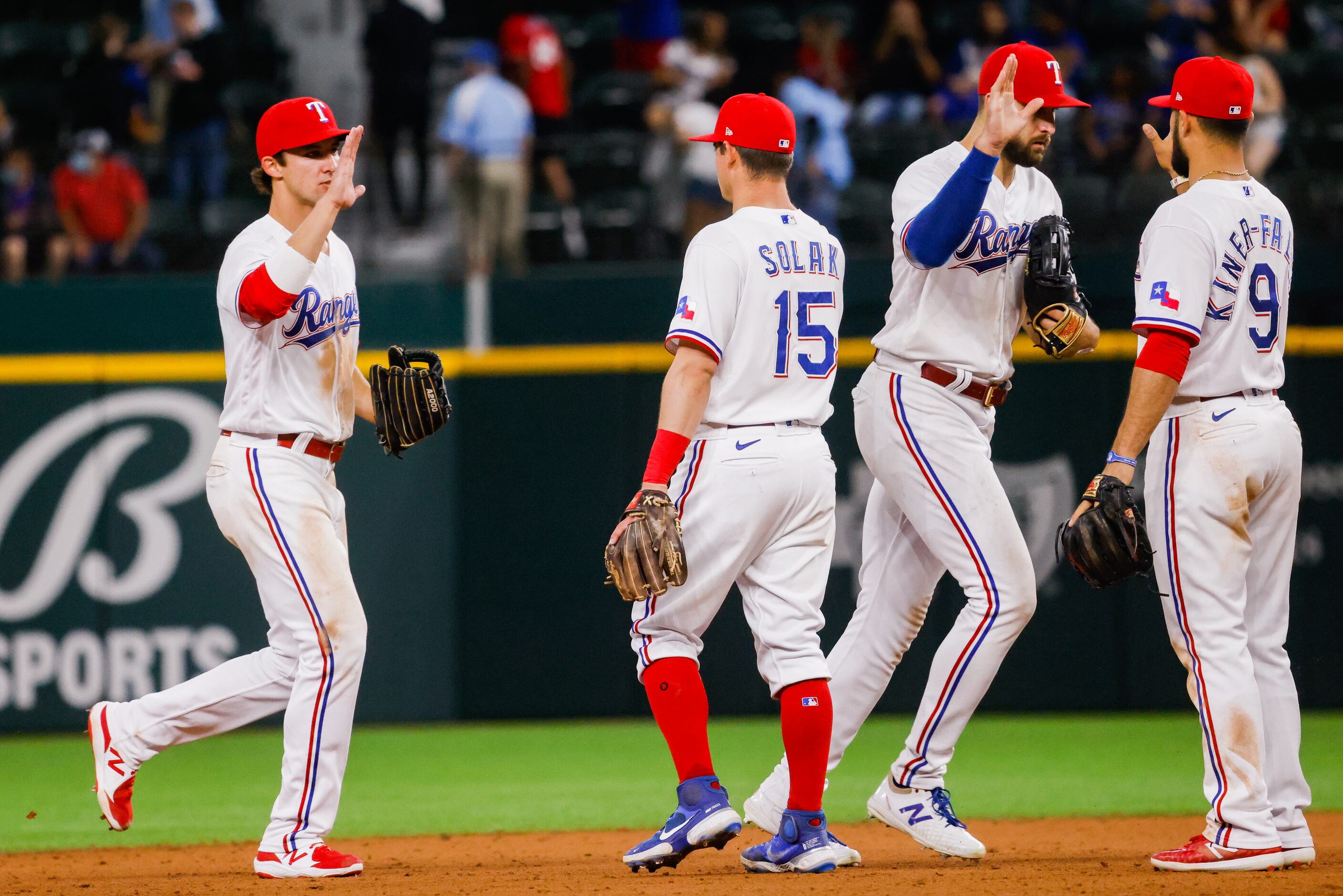 The Texas Rangers celebrate defeating the Los Angeles Angels at Globe Life Field on Tuesday,...