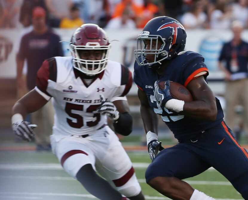 UTEPs Aaron Jones runs away from New Mexico States Rodney Butler during an NCAA college...