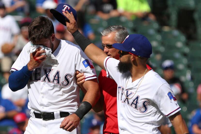 Texas Rangers third baseman Joey Gallo (13) gets his hat returned to him by Rougned Odor...