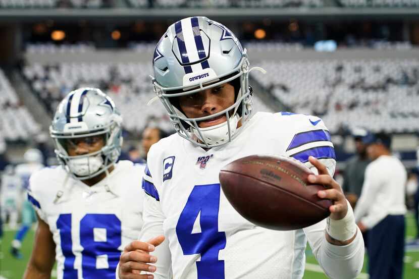 Dallas Cowboys quarterback Dak Prescott warms up before an NFL football game against the...