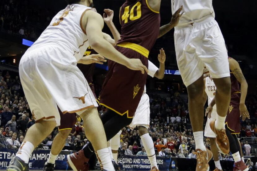 Texas center Cameron Ridley (55) goes up for the game-winning shot against Arizona State...
