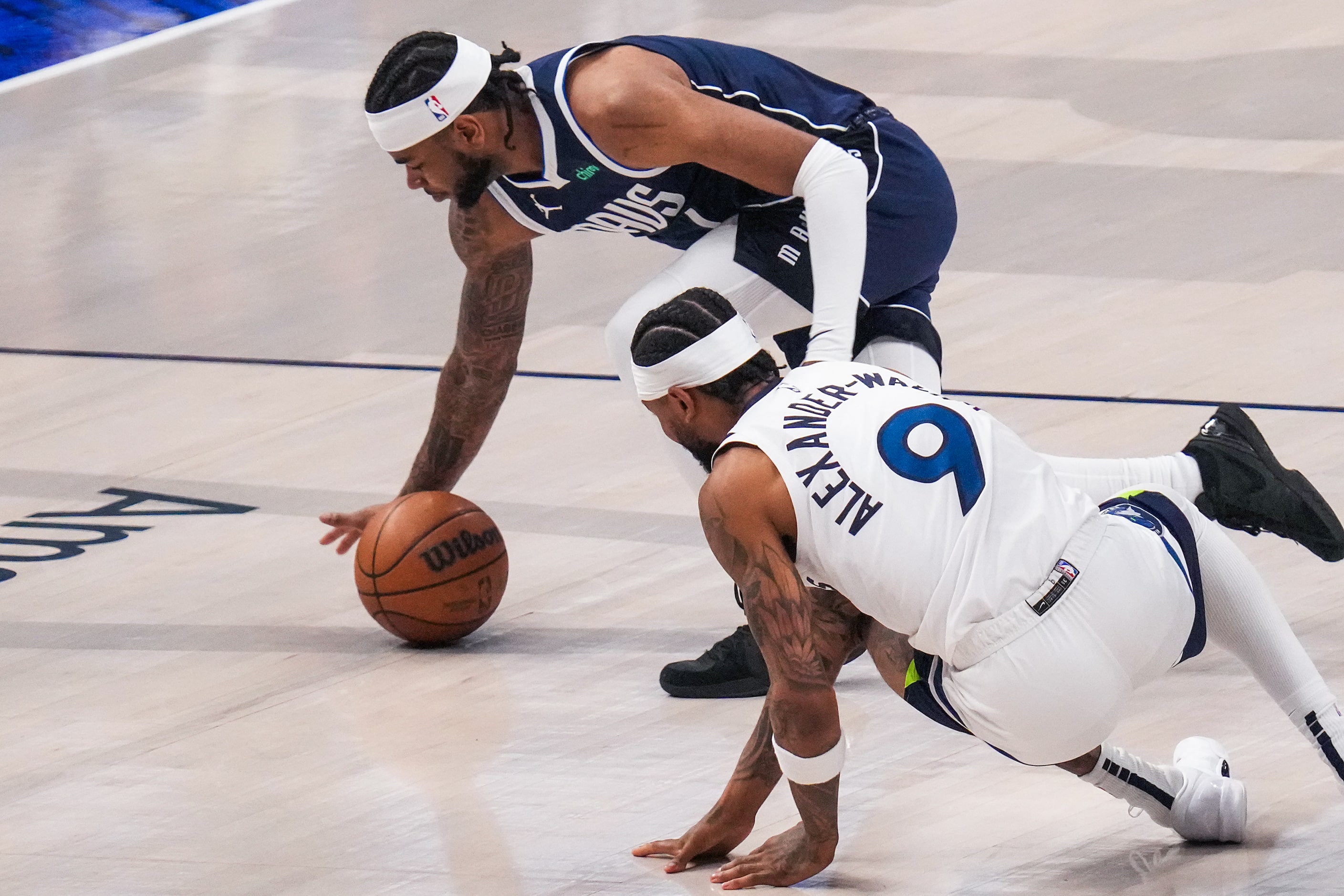 Dallas Mavericks guard Jaden Hardy (1) scrambles for a loose against Minnesota Timberwolves...