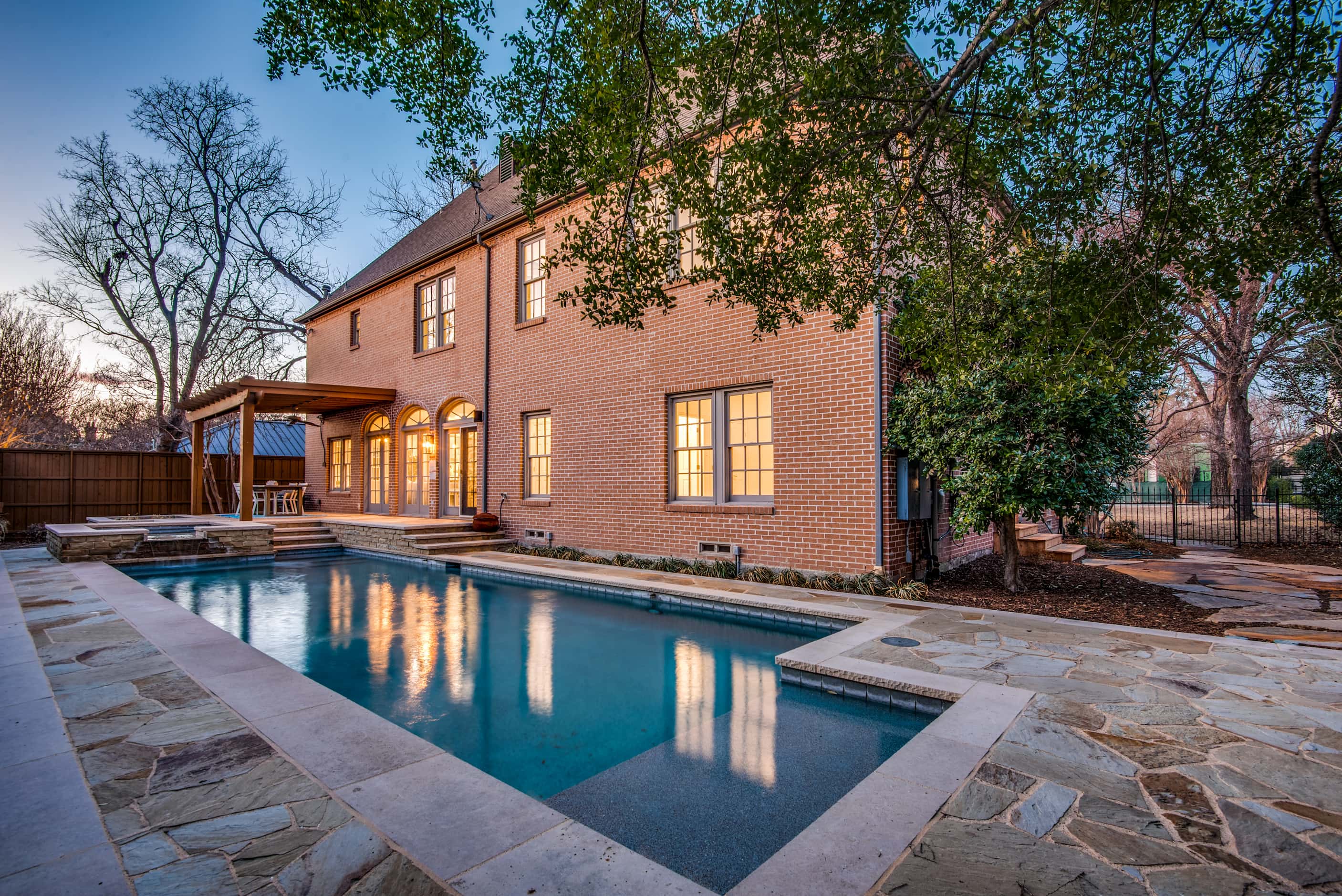 The backyard features a pool, a covered patio, and a side yard.
