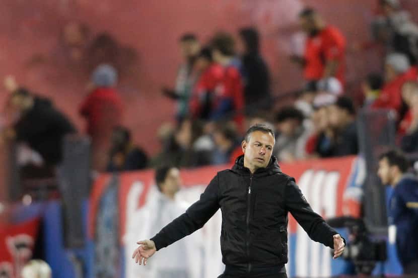FC Dallas head coach Nico Estevez reacts from the team bench area after a missed scoring...