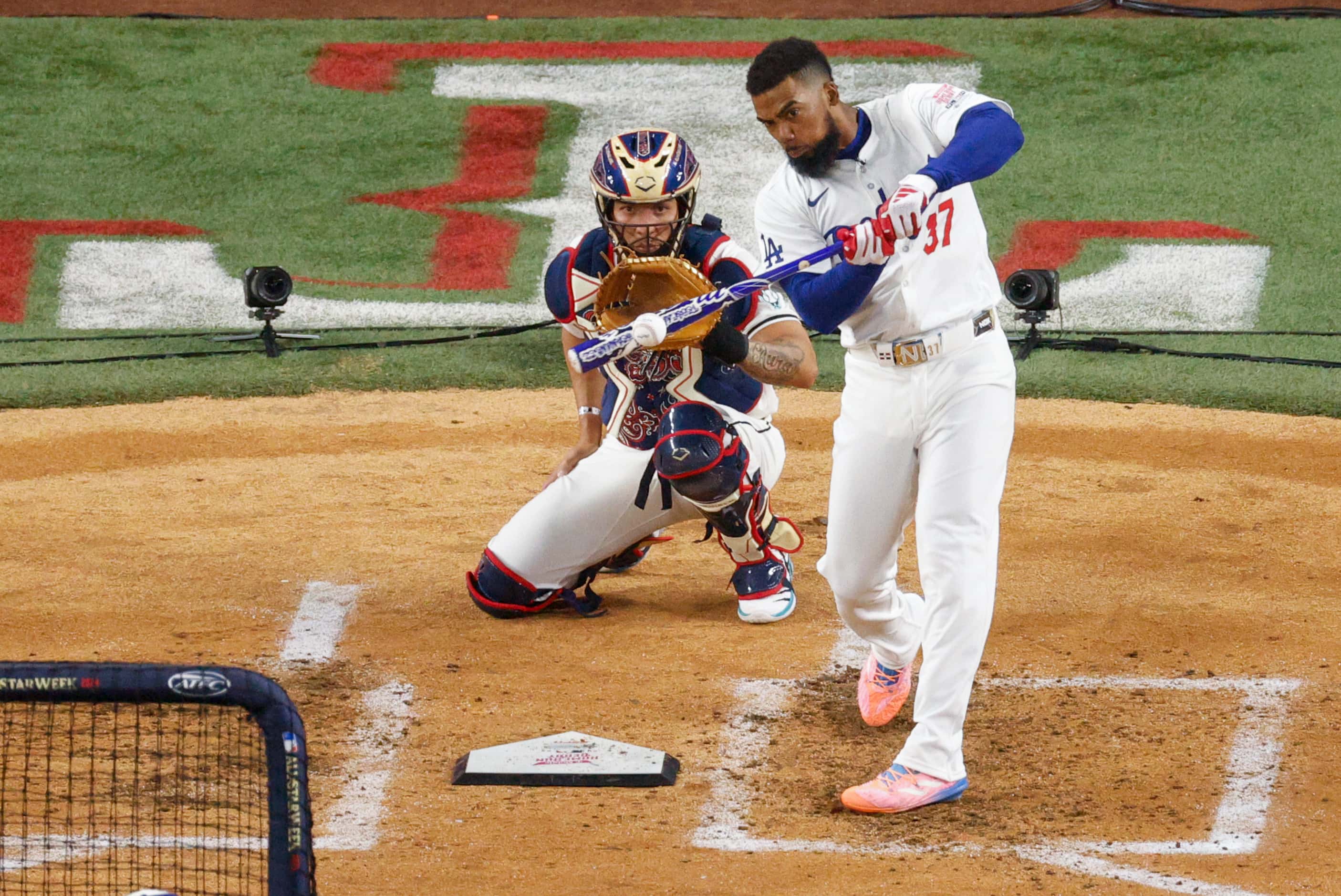 National League's Teoscar Hernández, of the Los Angeles Dodgers, connects for a home run...