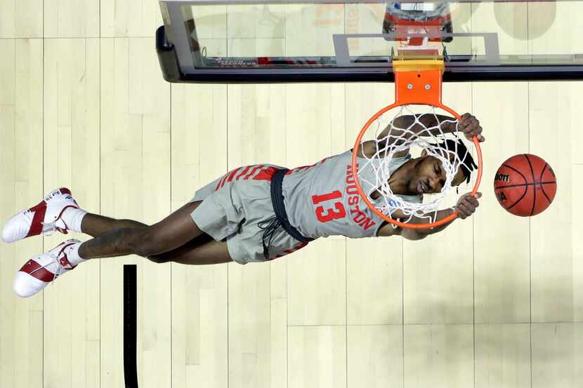 Houston's DeJon Jarreau dunks the ball during the first half of a first round men's college...