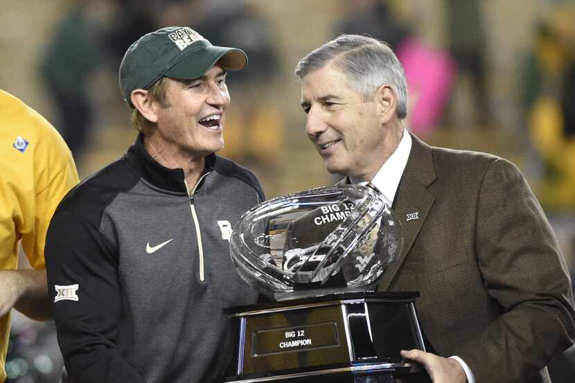Baylor Bears head coach Art Briles accepts the Big XII trophy from Big XII commissioner Bob...