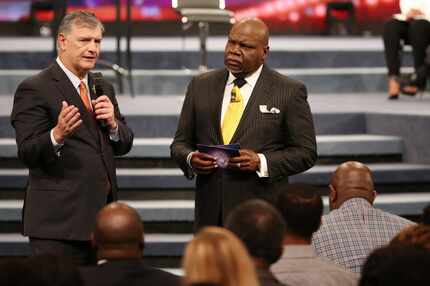 Dallas Mayor Mike Rawlings, left, speaks about issues of race and healing with Bishop T.D....