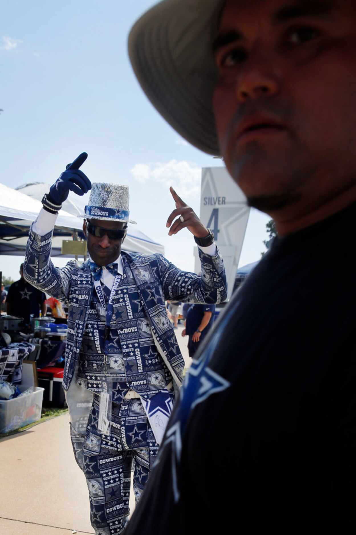 Dallas Cowboys fans James 'The Suitman 1' Wright dances during a tailgate party before the...