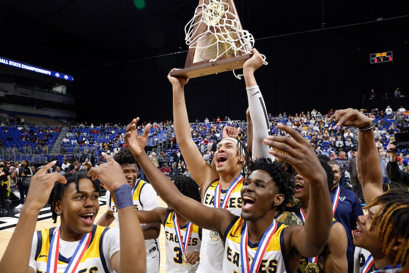 Oak Cliff Faith Family Academy center Doryan Onwuchekwa (11) raises the Class 4A state...