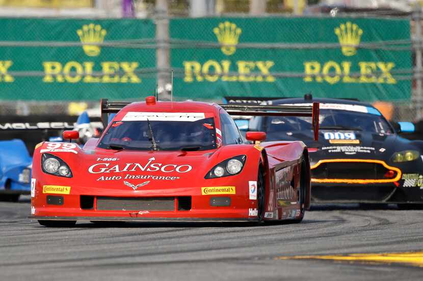 Alex Gureny, front, passes several cars as he drives the GAINSCO Corvette DP through a...