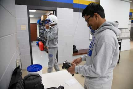 Sunnyvale High School sophomore Ryan Mathew, the football team manager, prepares for a...