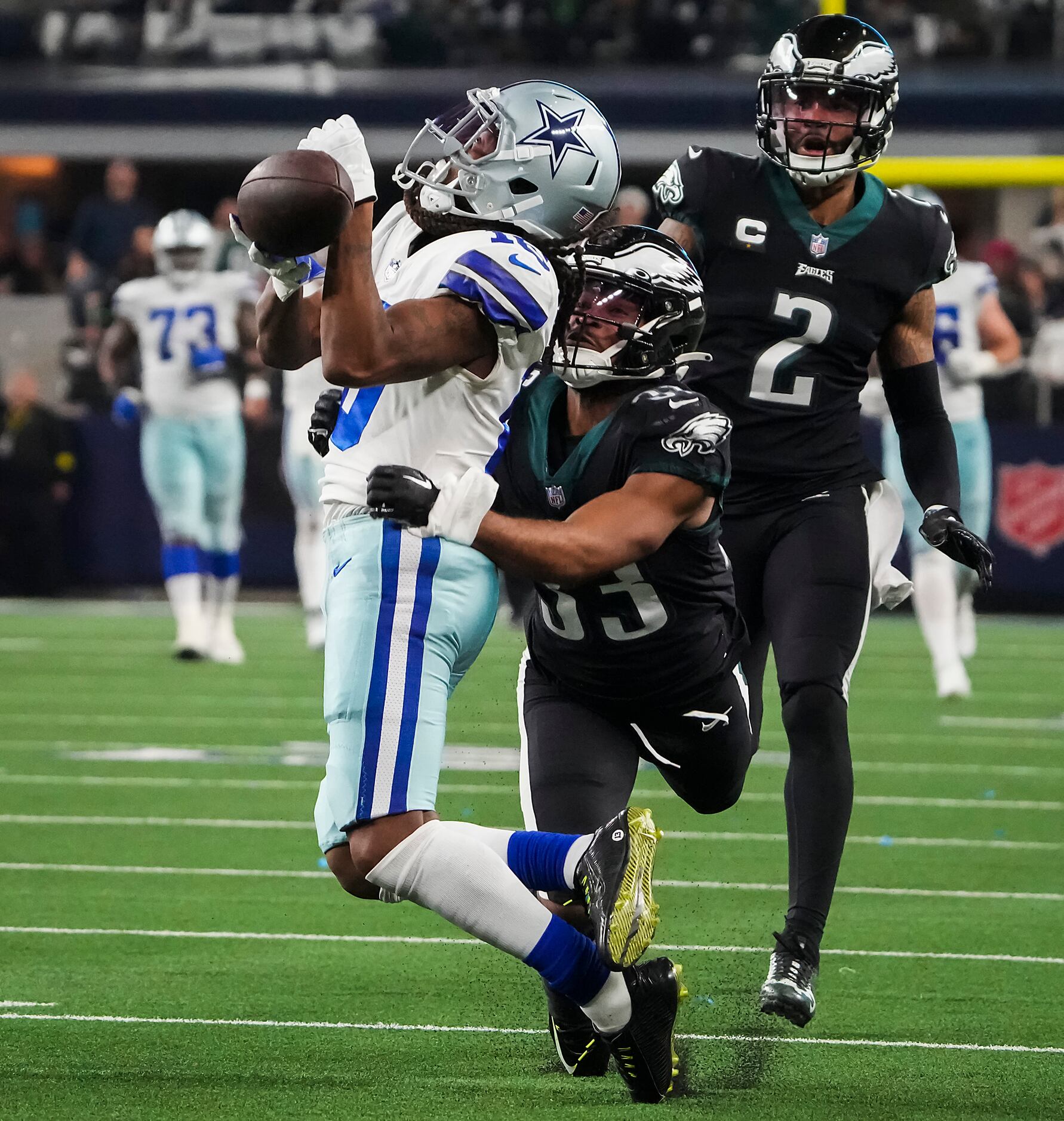 Arlington, United States. 24th Dec, 2022. Dallas Cowboys Dak Prescott gets  stopped by Philadelphia Eagles Brandon Graham, left, and Ndamukong Suh  during their NFL game at AT&T Stadium in Arlington, Texas on