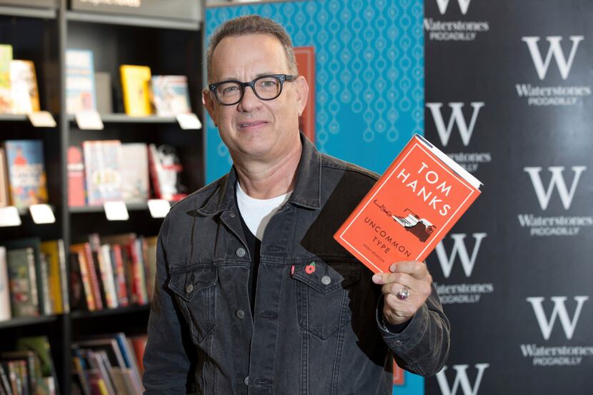 Actor Tom Hanks poses for photographers at a signing of his new book 'Uncommon Type', in...