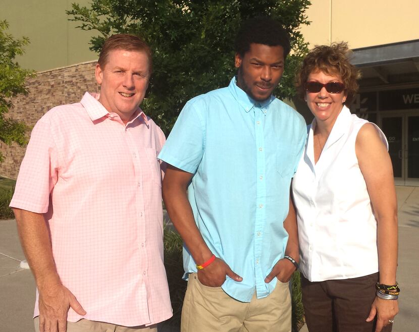 Dave and Lisa Stephenson pose with Thomas Johnson at their church in Plano in July 2014....