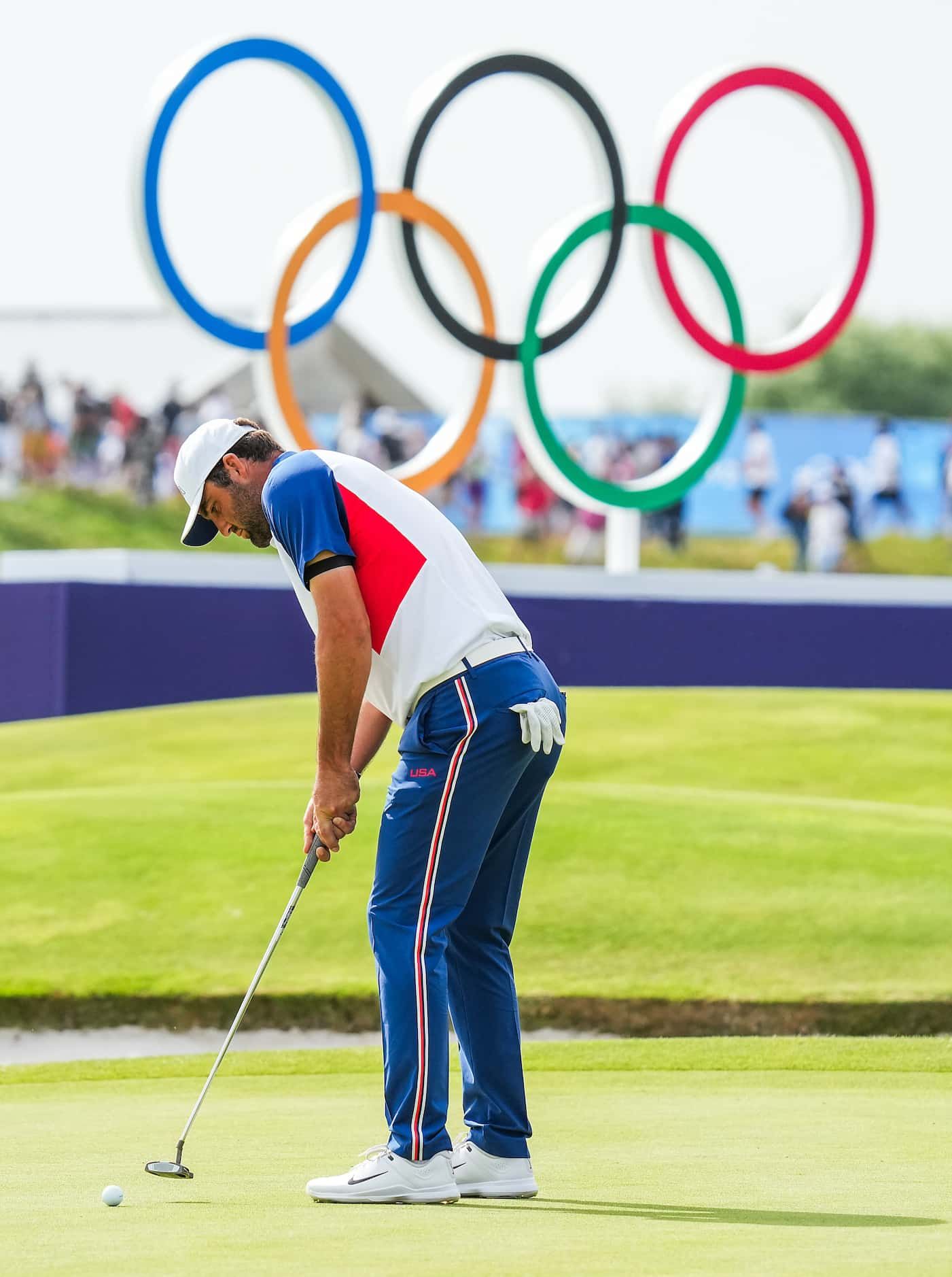 Scottie Scheffler of the United States sinks a putt for par on the 18th green during the...