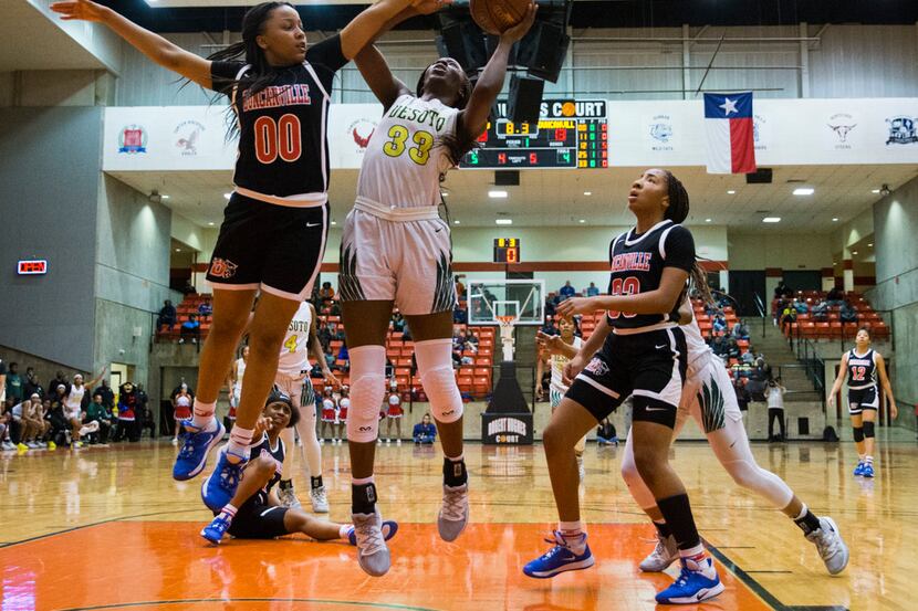 DeSoto's Amina Muhammad (33) goes up for a shot while Duncanville's Hope LeMelle (00)...