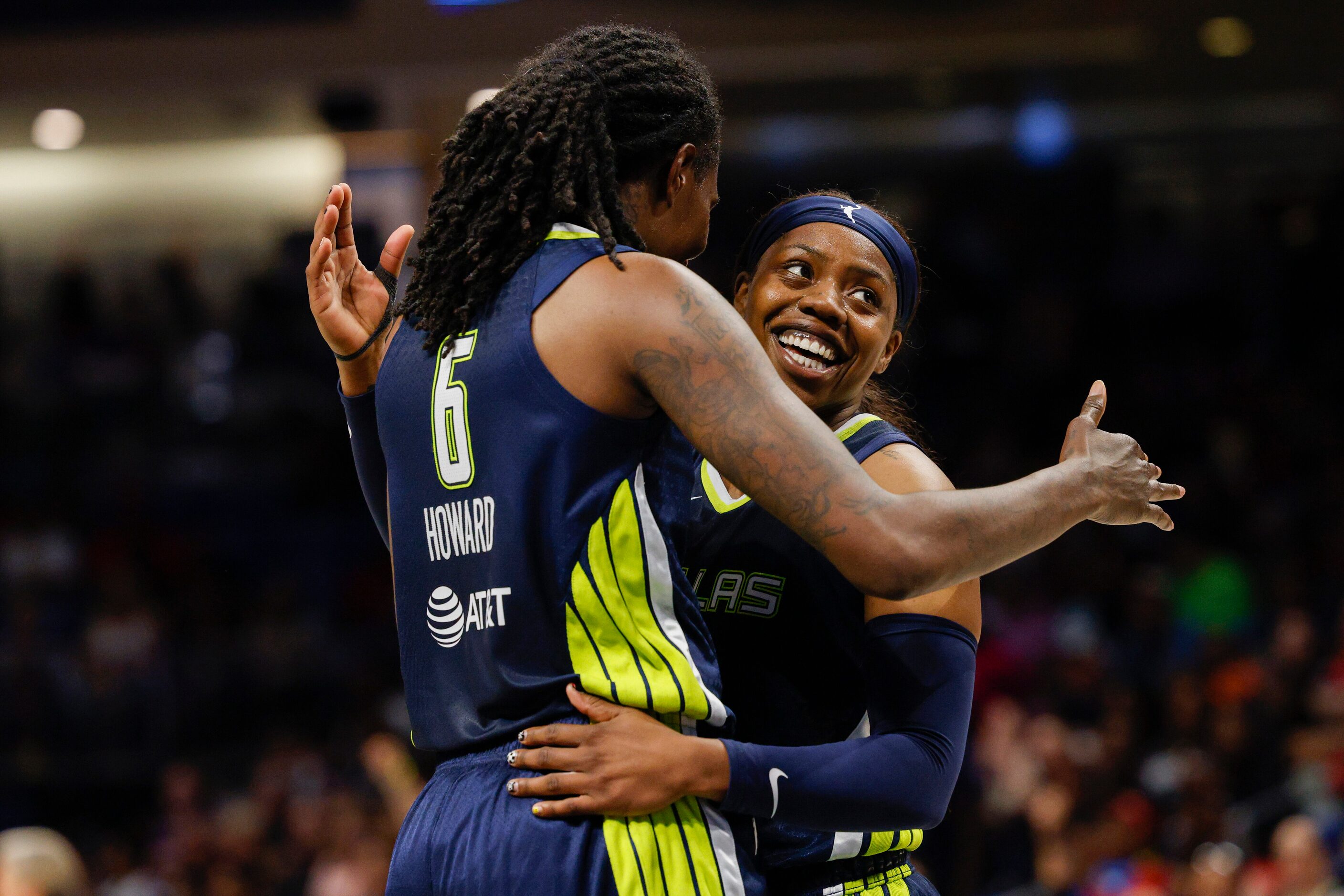 Dallas Wings guard Arike Ogunbowale (24) celebrates a basket with forward Natasha Howard (6)...