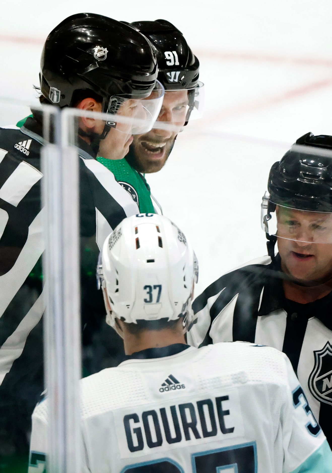 Dallas Stars center Tyler Seguin (91) eyes Seattle Kraken center Yanni Gourde (37) after a...