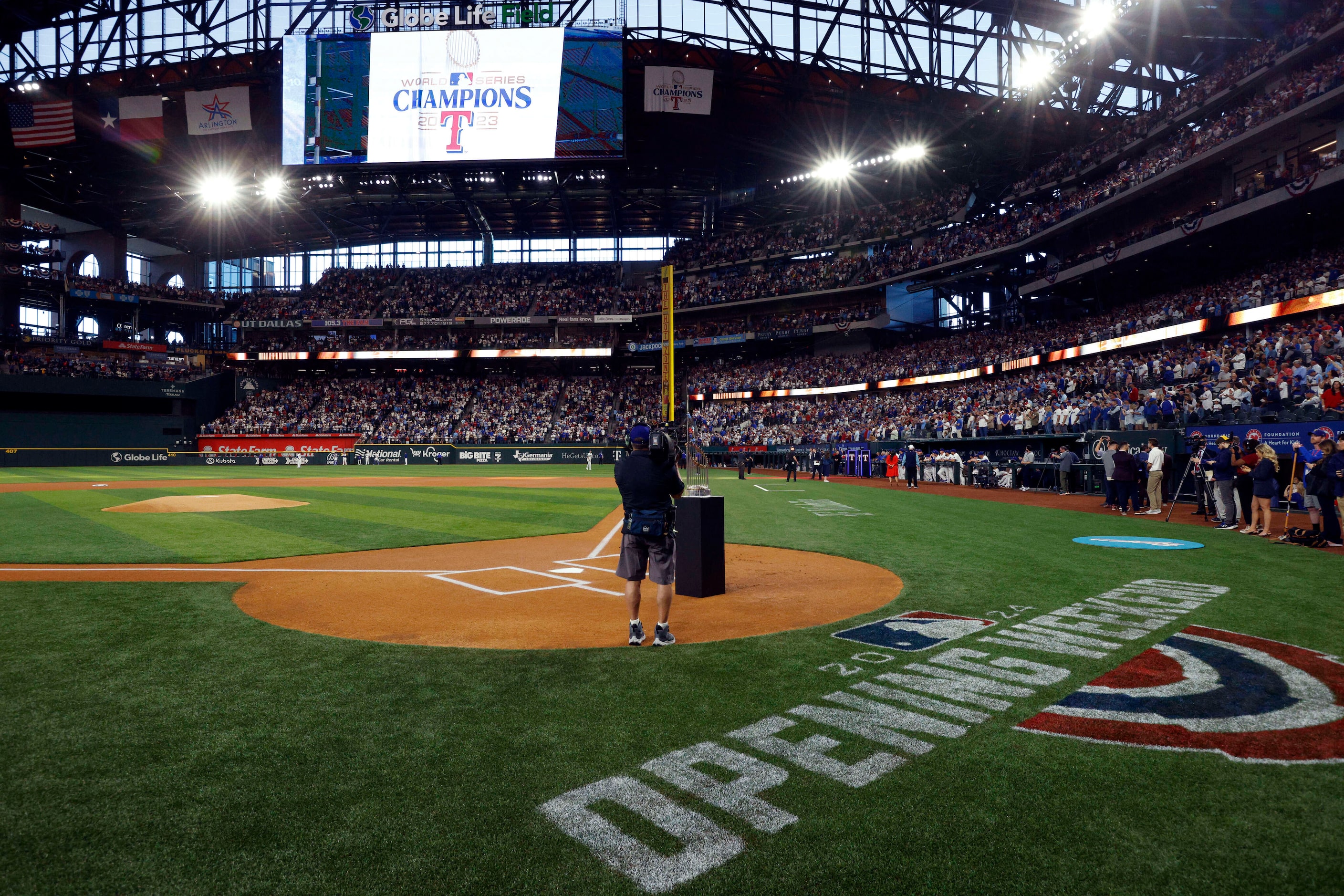 The Texas Rangers World Series championship banner is unfurled from the rafters before the...