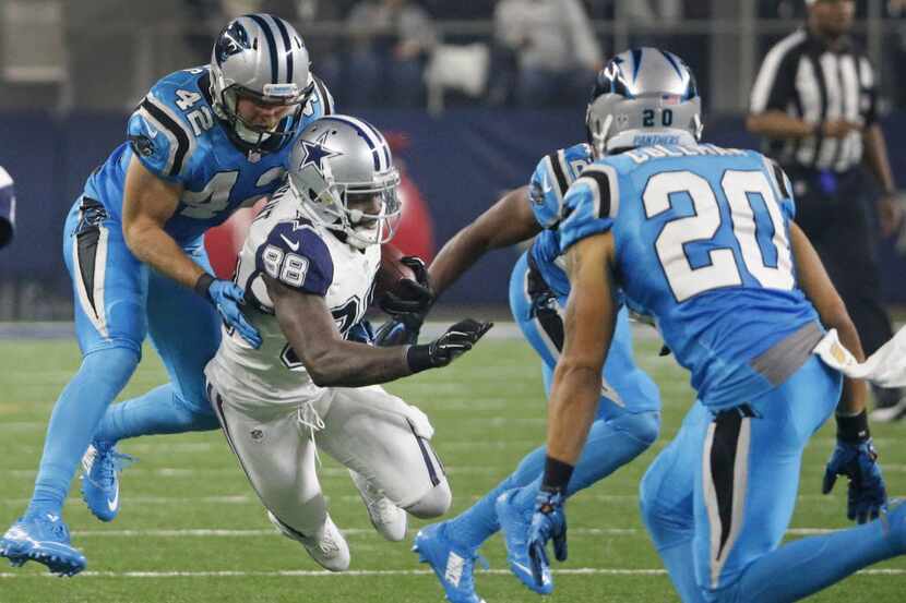 Dallas Cowboys wide receiver Dez Bryant (88) is brought down by Carolina Panthers defensive...