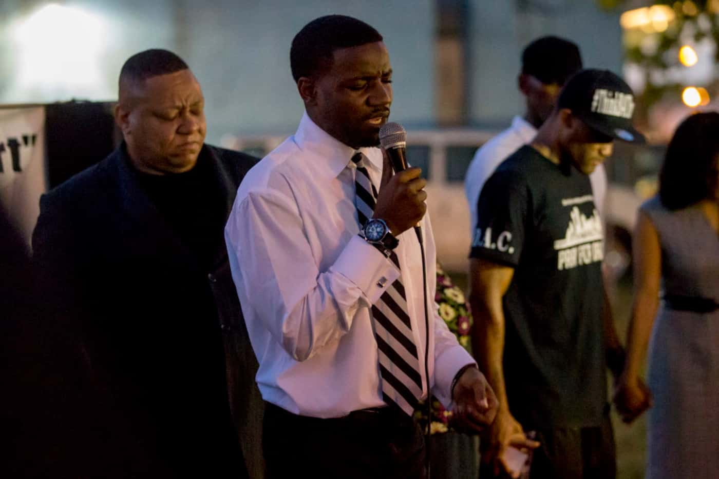Dominique Alexander, president and founder of Next Generation Action Network, prays during...