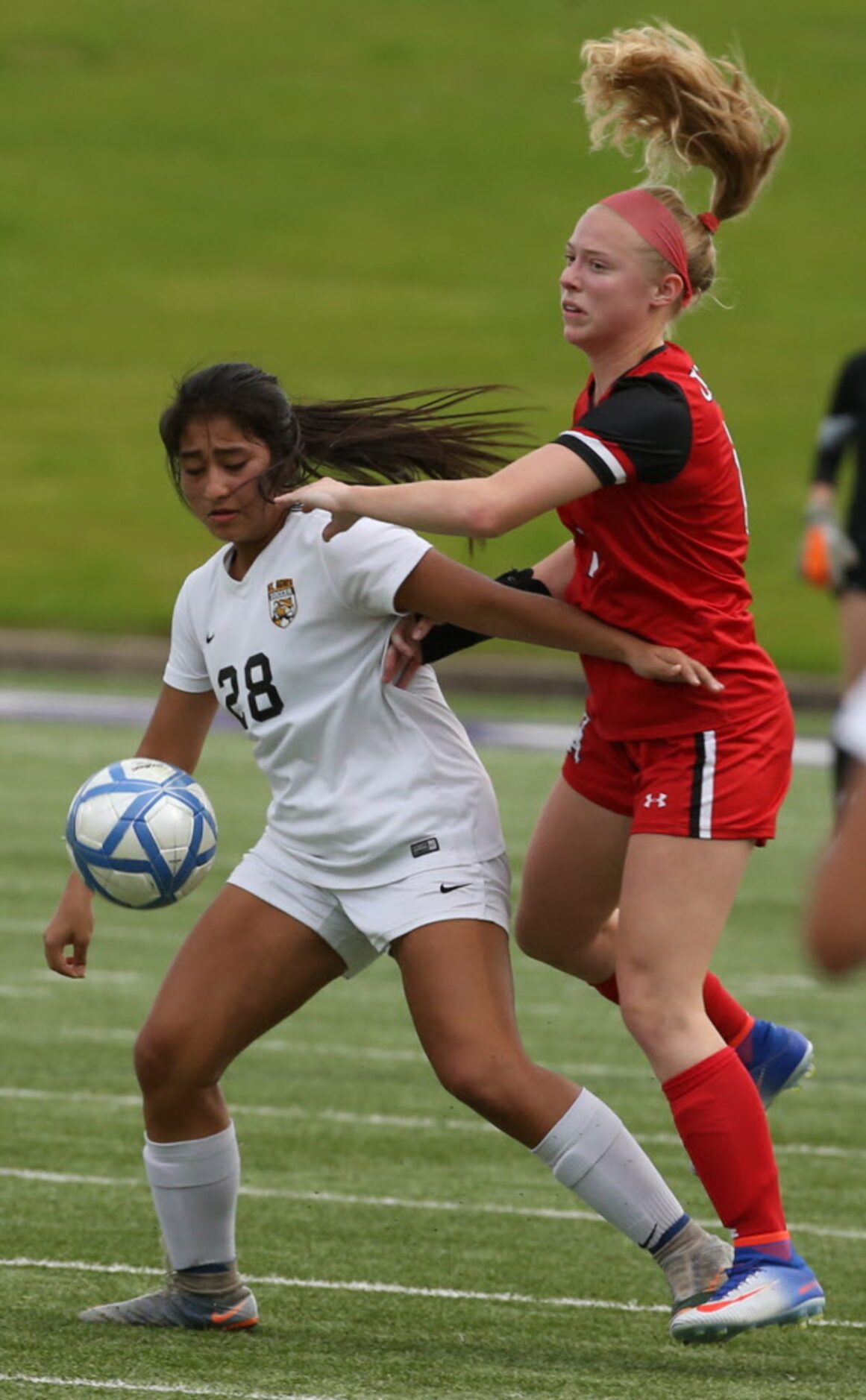 St. Agnes Academys Megan Mirza (28) and Ursuline Academys Jayden Gill (8) fight for the...