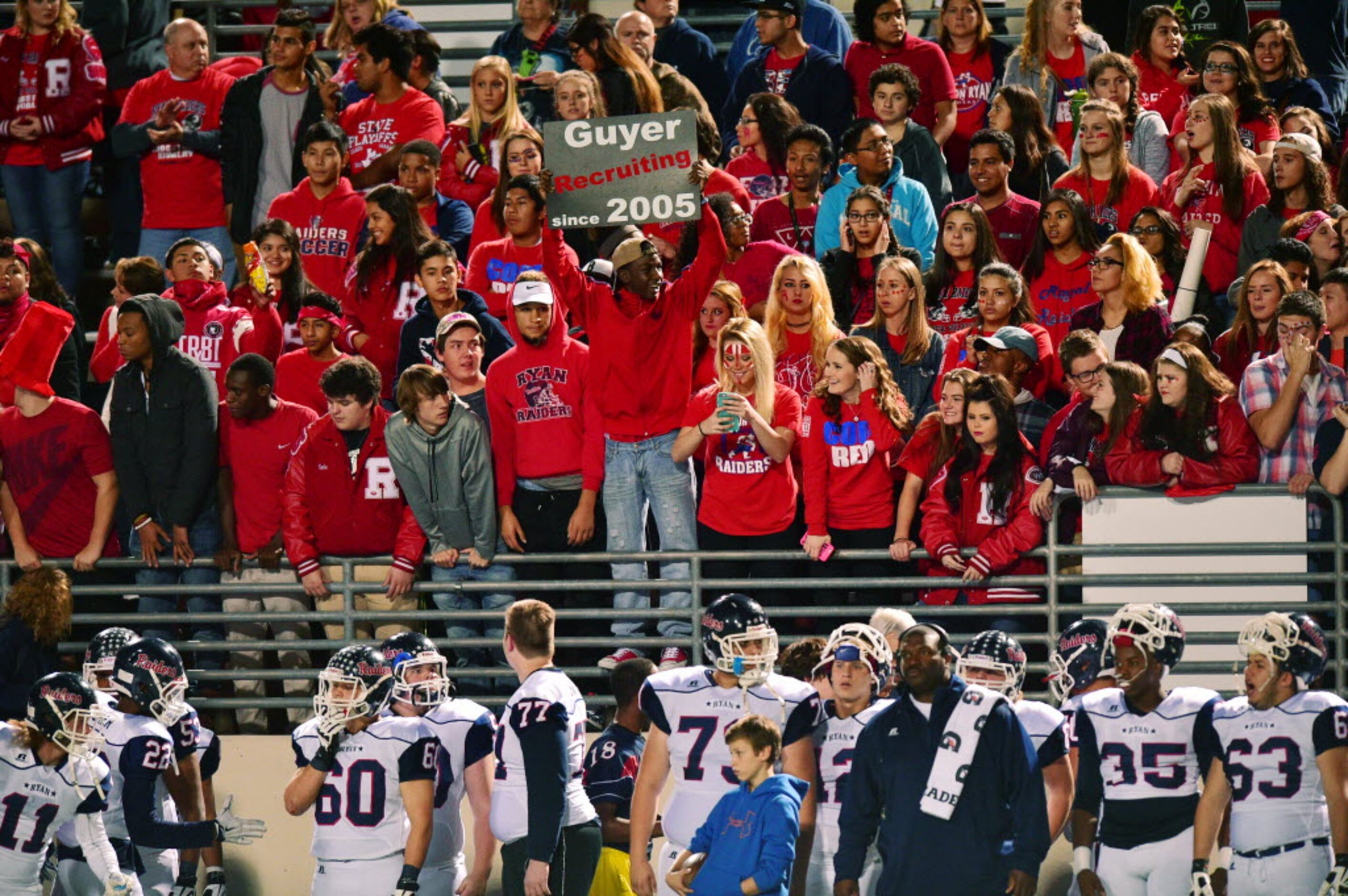 A Ryan student holds up a sign in the stands during the game against Guyer, Friday, November...