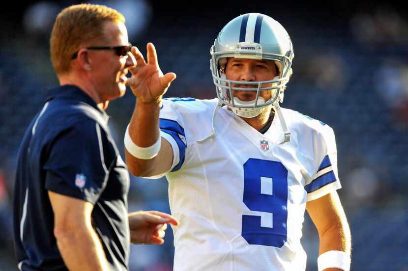 Dallas Cowboys head coach Jason Garrett (left) and quarterback Tony Romo (9) before a...