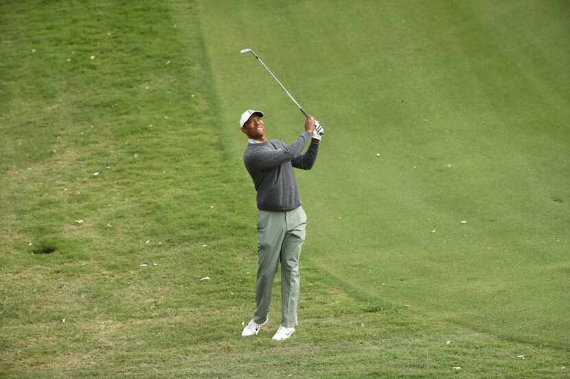 AUSTIN, TEXAS - MARCH 30: Tiger Woods of the United States plays a shot on the 18th hole in...