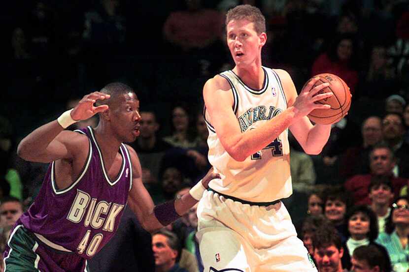 FILE - In this Nov. 22, 1997, file photo, the Mavericks' Shawn Bradley (44) looks to pass as...