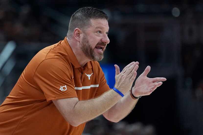 Texas head coach Chris Beard talks to his players during the first half of an NCAA college...