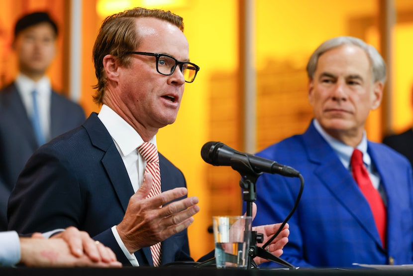 Speaker of the Texas House Dade Phelan (left) shares his remarks as Gov. Greg Abbott looks...