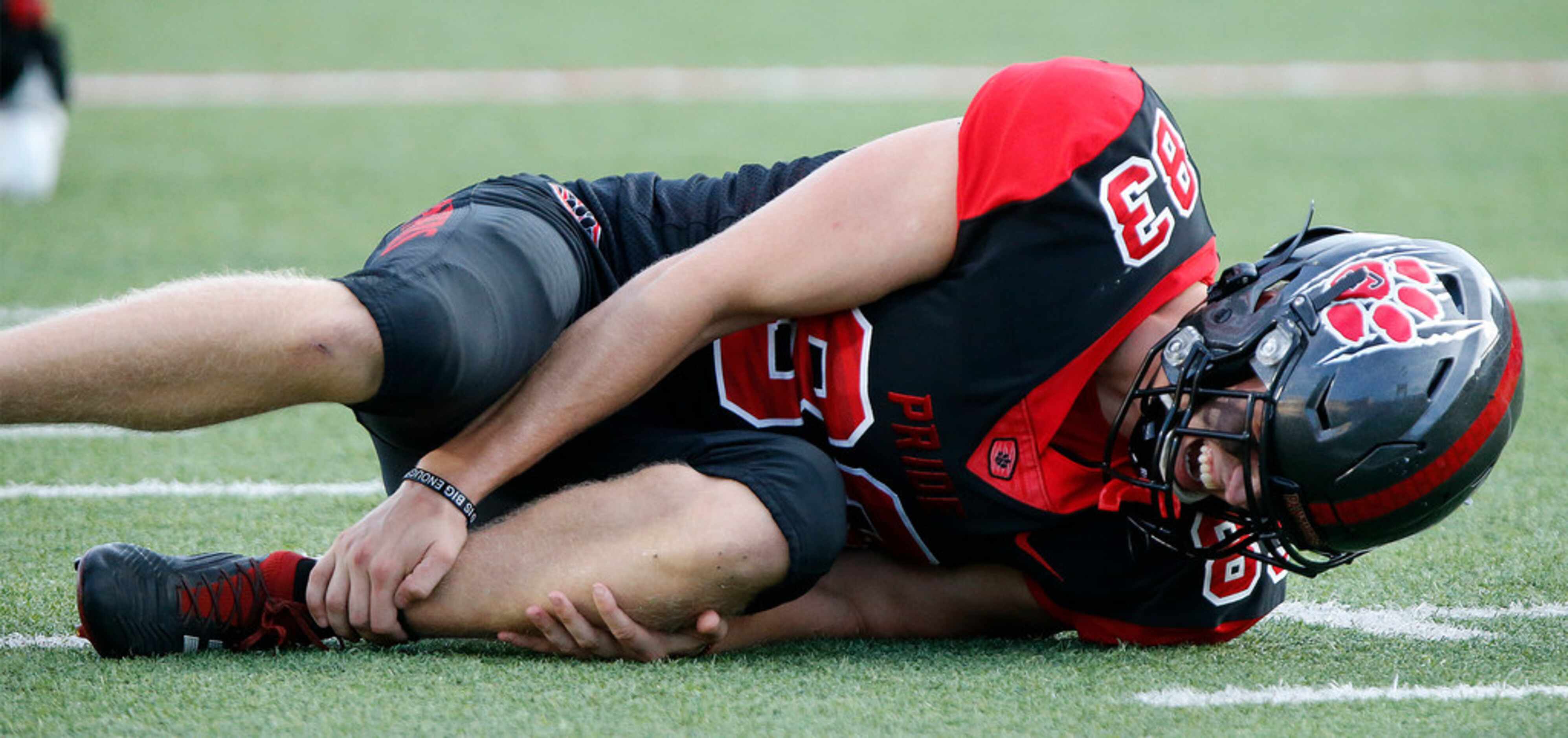 Colleyville Heritage High School punter Chase Allen (83) suffers an ankle injury early in...