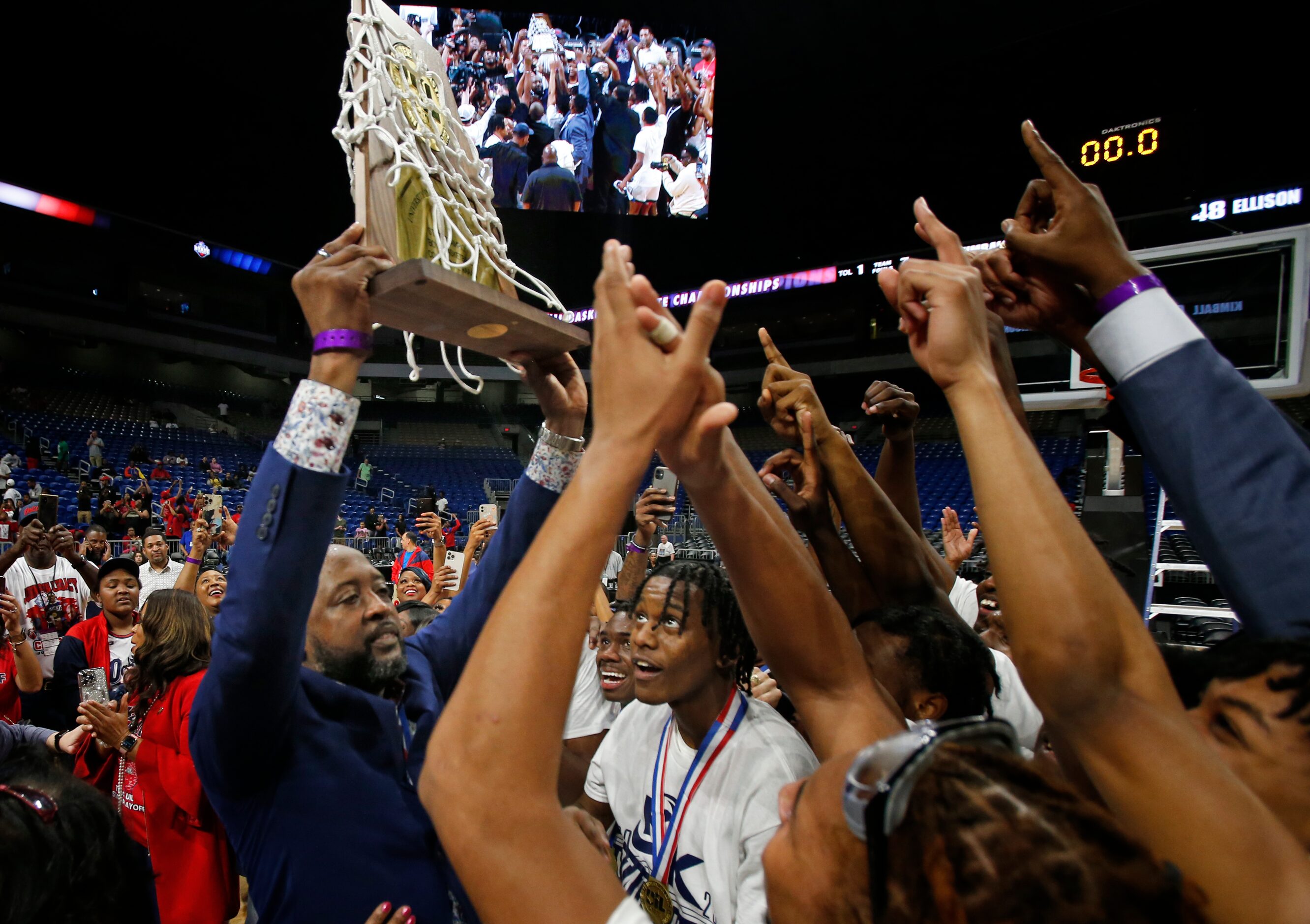 Dallas Kimball head coach Nicke Smith holds up the trophy for his team. Dallas Kimball...